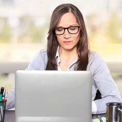 Woman wearing computer glasses while on her laptop