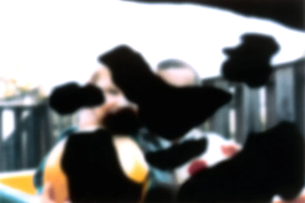 Two boys holding balls, with dark blotches covering parts of the scene